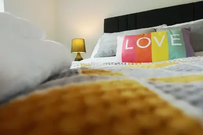 a bed with a pillow with the word love on it at Tree View Apartment in Chesterton