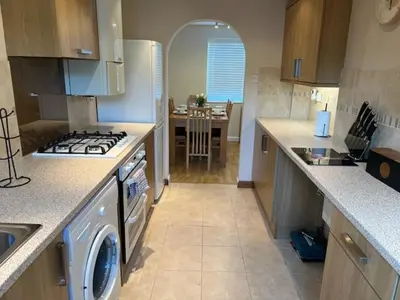 a kitchen with a stove top oven next to a sink at Tree View Apartment in Chesterton