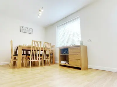 a dining room with a table and chairs and a window at Tree View Apartment in Chesterton