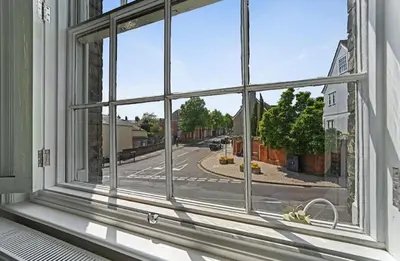 a window in a building with a view of a street at 119 Flat 2 Northgate st - Stylish one bedroom apartment set within walking distance to town, spacious living space with public car park close by in Bury Saint Edmunds