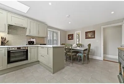 a kitchen with a table and a dining room at 119 Flat 2 Northgate st - Stylish one bedroom apartment set within walking distance to town, spacious living space with public car park close by in Bury Saint Edmunds