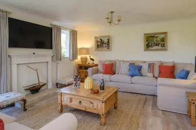 a living room with a couch and a coffee table at 9 The Coastguards in Thorpeness