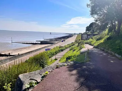 a road next to a beach next to the water at Lola’s Caravan. Your home away from home. in Parkeston