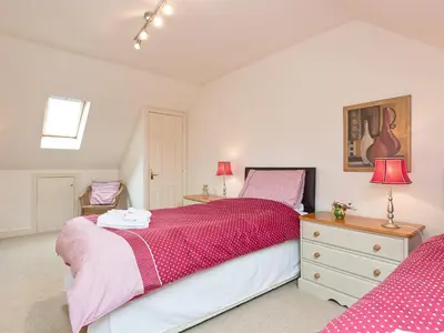 a bedroom with a bed and a dresser and two lamps at Jubileum Lodge Uk27999 in Watton