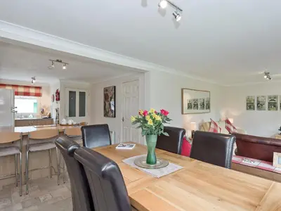 a dining room and living room with a table and chairs at Jubileum Lodge Uk27999 in Watton