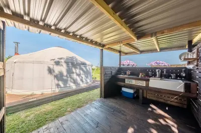 a bathroom with a sink and a large tent at Luxury glamping in Constable Country - Valley View Yurt in Edwardstone