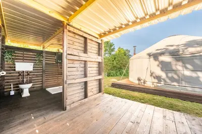 a yurt with a toilet on a wooden deck at Luxury glamping in Constable Country - Valley View Yurt in Edwardstone