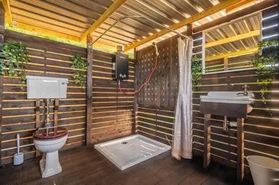 a bathroom with a toilet and a sink at Luxury glamping in Constable Country - Valley View Yurt in Edwardstone