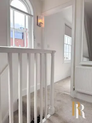 a white staircase in a white room with a window at Fisherman's Cottage - Harwich Breaks - BRAND NEW - long stays available great prices - get in touch for all bookings - cottage in harwich - beach stay in Harwich