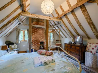 a bedroom with a large bed in a room at The Old Bike Shop in Brockdish