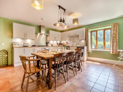 a kitchen with a large wooden table and chairs at St Mary's Chapel in New Buckenham