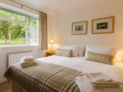 a bedroom with a bed and a window at Covert Cottage in Gasthorpe