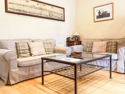a living room with a couch and a glass table at Valley Farm Cottage in Sudbourne