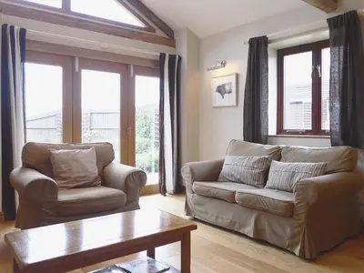 a living room with a couch and a coffee table at Barn Owl Cottage in Sudbourne