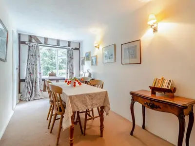 a dining room with a table and a window at Oaklawn Cottage in Eye