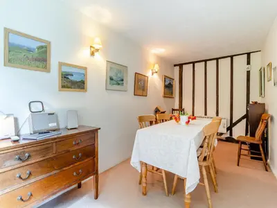 a dining room with a table and chairs at Oaklawn Cottage in Eye