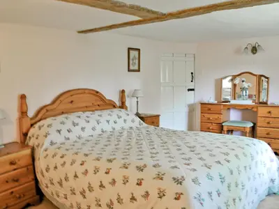 a bedroom with a bed and a dresser at The Old House in Mellis