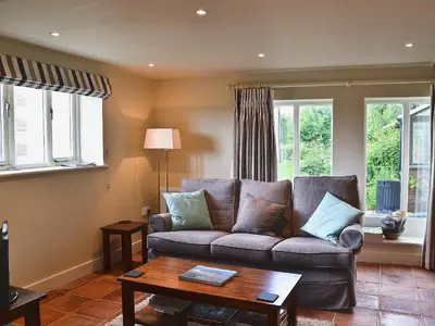 a living room with a couch and a table at The Granary in Stuston