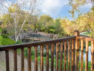a wooden fence with a view of a park at Swallows Nest in Saint Lawrence