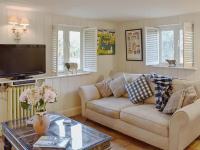 a living room with a couch and a coffee table at Swallows Nest in Saint Lawrence