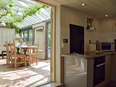 a kitchen with a table and a dining room at Swallows Nest in Saint Lawrence