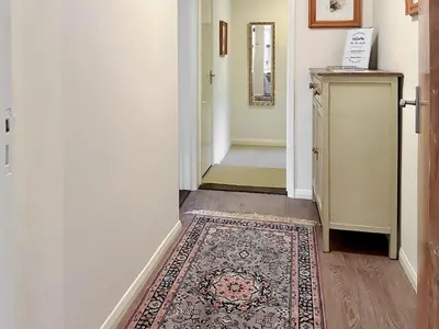 a hallway with a rug on the floor and a door at The Cottage in Fressingfield