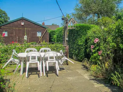 a white table and chairs in a garden at Heath View Cottage in Westleton