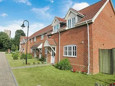 a brick house with a street light in front of it at Dormers in Leiston