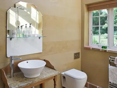 a bathroom with a sink and a toilet at The Coach House in Saxmundham
