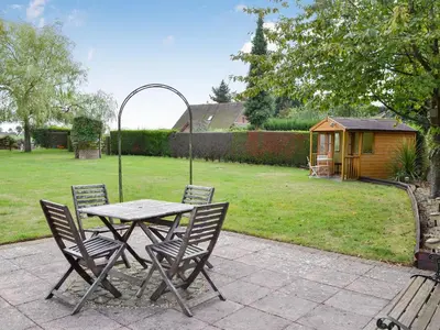 a table and chairs in a yard with a backyard at The Mount in Boxford