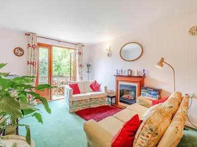 a living room with a couch and a fireplace at Bryanstown Annexe in Woodbridge