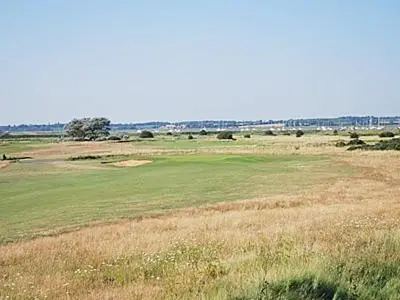 a field of grass with trees in the distance at Mariners Lodge in Felixstowe