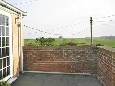 a brick wall in front of a house at Mariners Lodge in Felixstowe