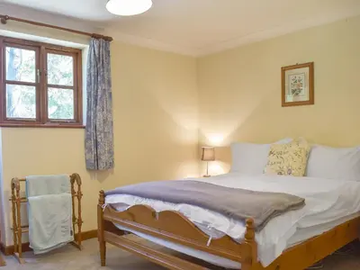 a bedroom with a bed and a window at Coach House in Melton