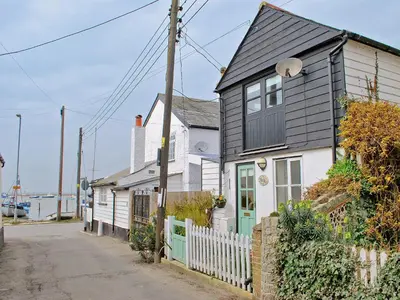 a white and black house with a black roof at Stoker Loft in West Mersea