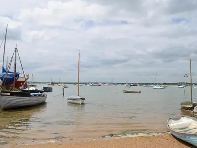 a group of boats sitting in the water at Stoker Loft in West Mersea