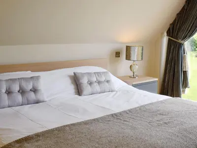 a bedroom with a large white bed with a window at The Glass Room in Dedham
