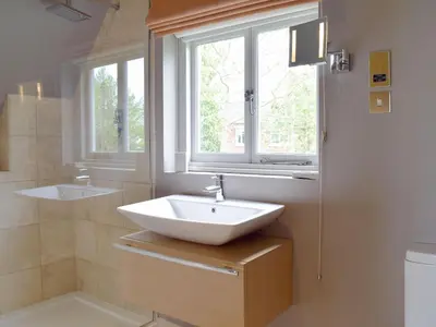 a bathroom with a sink and a window at The Glass Room in Dedham