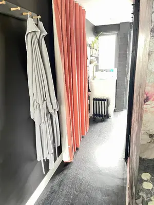 a hallway with orange curtains and a sink at The Big Slepe in St Ives
