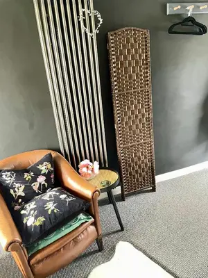 a living room with a chair and a table at The Big Slepe in St Ives
