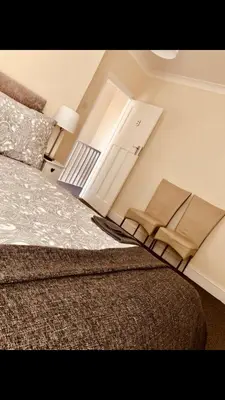 a bedroom with a bed and a door with towels on it at Ac lounge36 Room B in Rochford