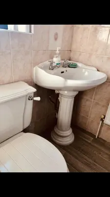 a bathroom with a white sink and a toilet at Ac lounge36 Room B in Rochford