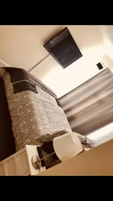 a bedroom with a bed and a tv on the ceiling at Ac lounge36 Room B in Rochford