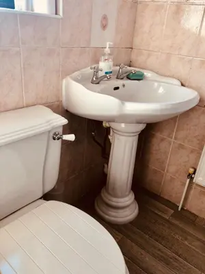 a bathroom with a white sink and a toilet at Ac lounge36 Room B in Rochford