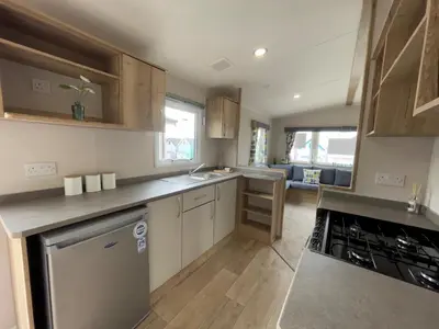 a kitchen with a sink and a stove top oven at Mersea Retreat in West Mersea