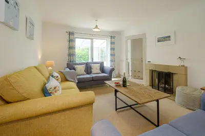 a living room with two couches and a fireplace at Annie's House in Thorpeness