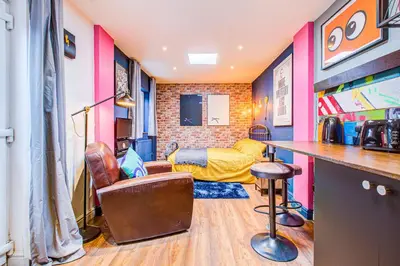 a room with a bar and a couch at Cosy Studio flat near hospital - Pass the Keys in Westcliff On Sea