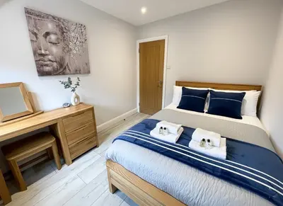 a bedroom with a bed with two towels on it at Luxurious apartment just off Mill Rd, near station - walk to historic city centre in Cambridge