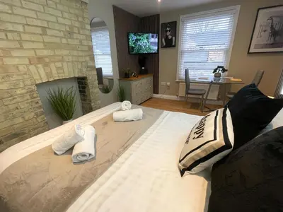 a living room with a bed with towels on it at City Studio - very best Location For exploring Cambridge - walk to station and City Centre in Cambridge