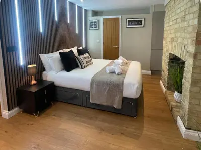 a bedroom with a bed with a teddy bear on it at City Studio - very best Location For exploring Cambridge - walk to station and City Centre in Cambridge